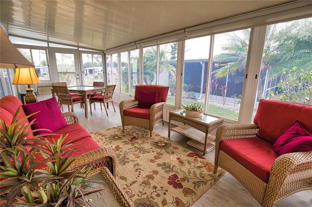 674 El Tango North Port, FL 34287 - Photo 29 of 85 a living room with furniture and a floor to ceiling window