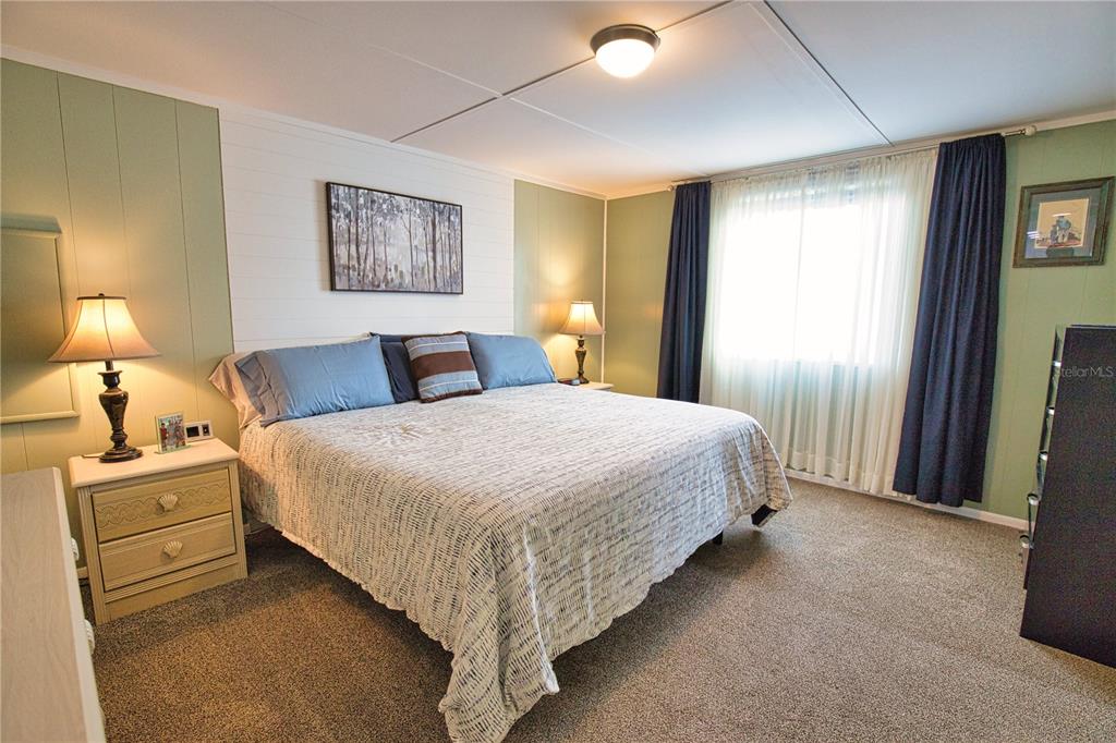 674 El Tango North Port, FL 34287 - Photo 32 of 85 a bedroom with a bed and lamp with window