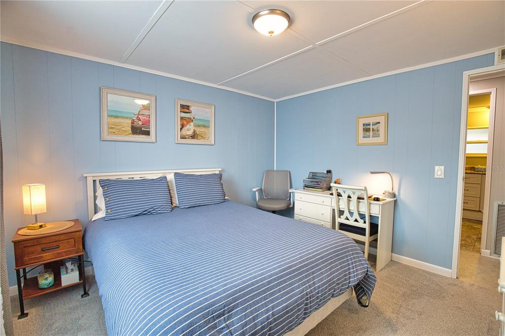674 El Tango North Port, FL 34287 - Photo 35 of 85 a bedroom with a bed and a lamp
