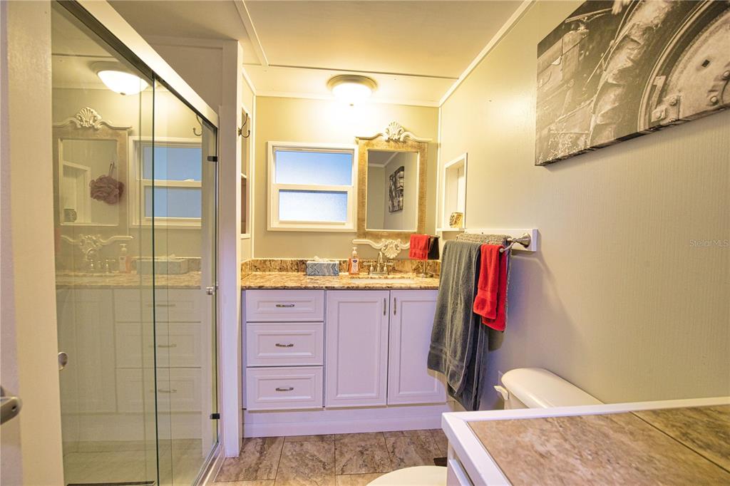 674 El Tango North Port, FL 34287 - Photo 37 of 85 a bathroom with a granite countertop sink and a mirror