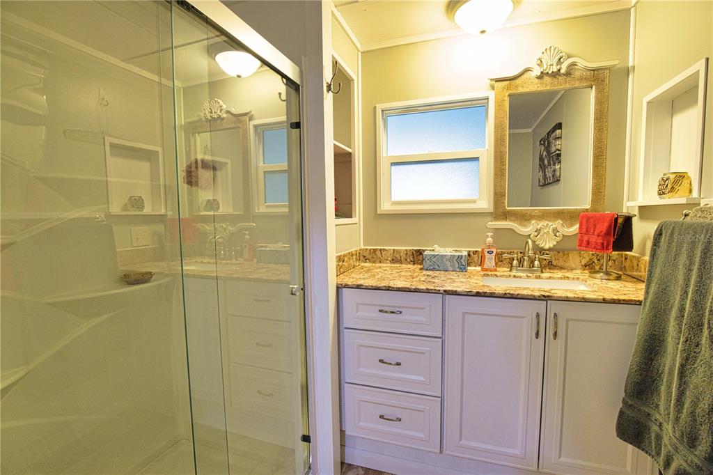 674 El Tango North Port, FL 34287 - Photo 38 of 85 a bathroom with a granite countertop sink and a mirror