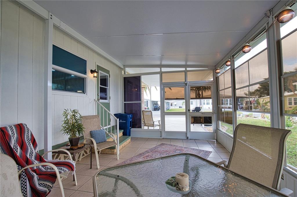 674 El Tango North Port, FL 34287 - Photo 6 of 85 a living room with furniture and a floor to ceiling window