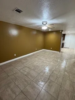 an empty room with a empty space and a ceiling fan