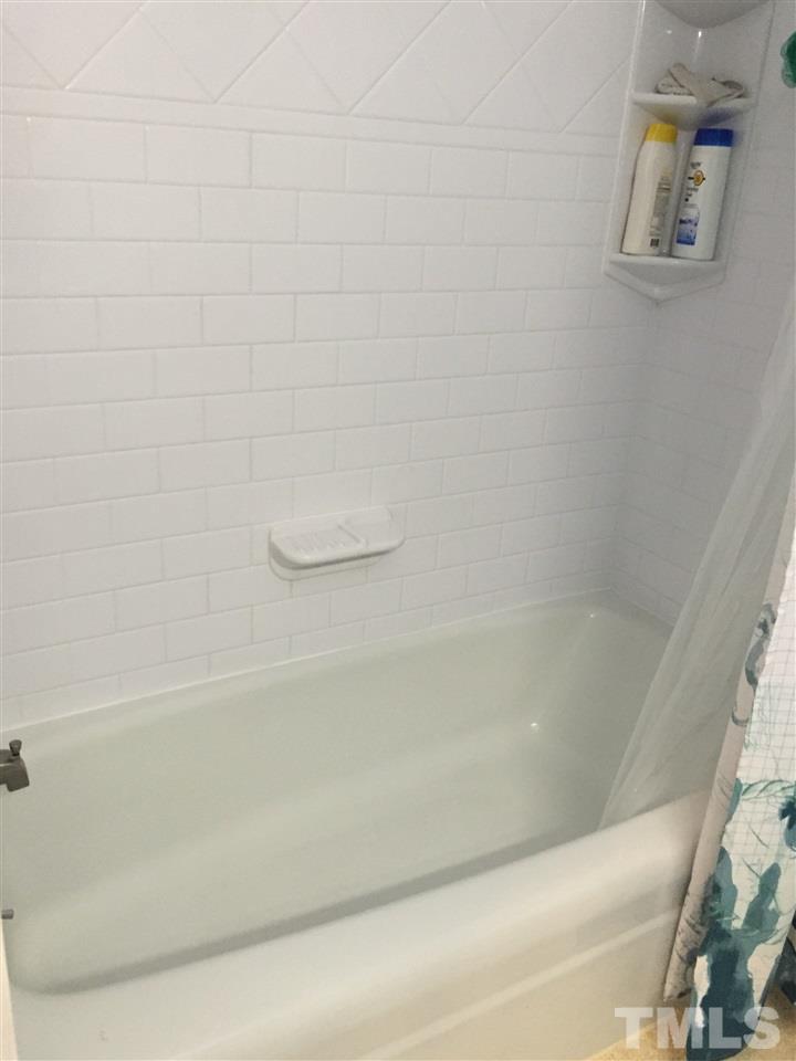 1244 Ridge Road Roxboro, NC 27573 - Photo 11 of 22 a close up of a bathtub with a shower