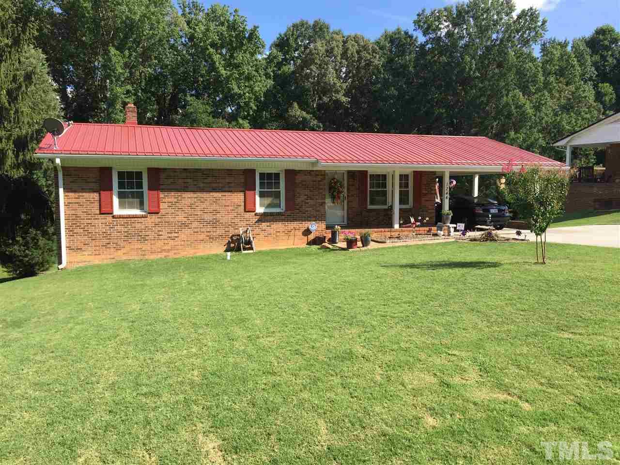 1244 Ridge Road Roxboro, NC 27573 - Photo 17 of 22 a view of a house with a yard porch and sitting area