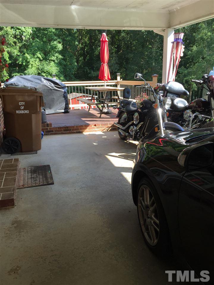 1244 Ridge Road Roxboro, NC 27573 - Photo 20 of 22 a view of a patio with table and chairs and a barbeque