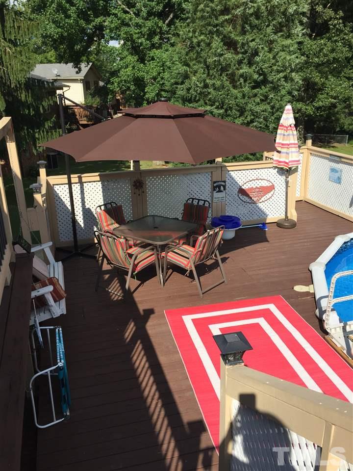 1244 Ridge Road Roxboro, NC 27573 - Photo 3 of 22 a view of a patio with table and chairs under an umbrella