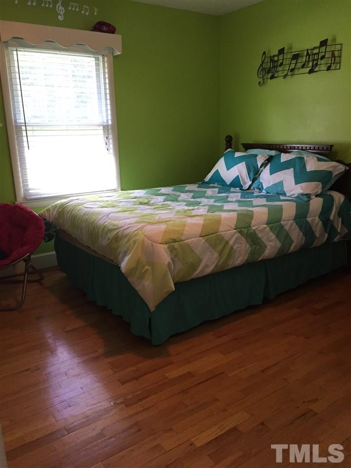 1244 Ridge Road Roxboro, NC 27573 - Photo 22 of 22 a bed sitting in a bedroom next to a window