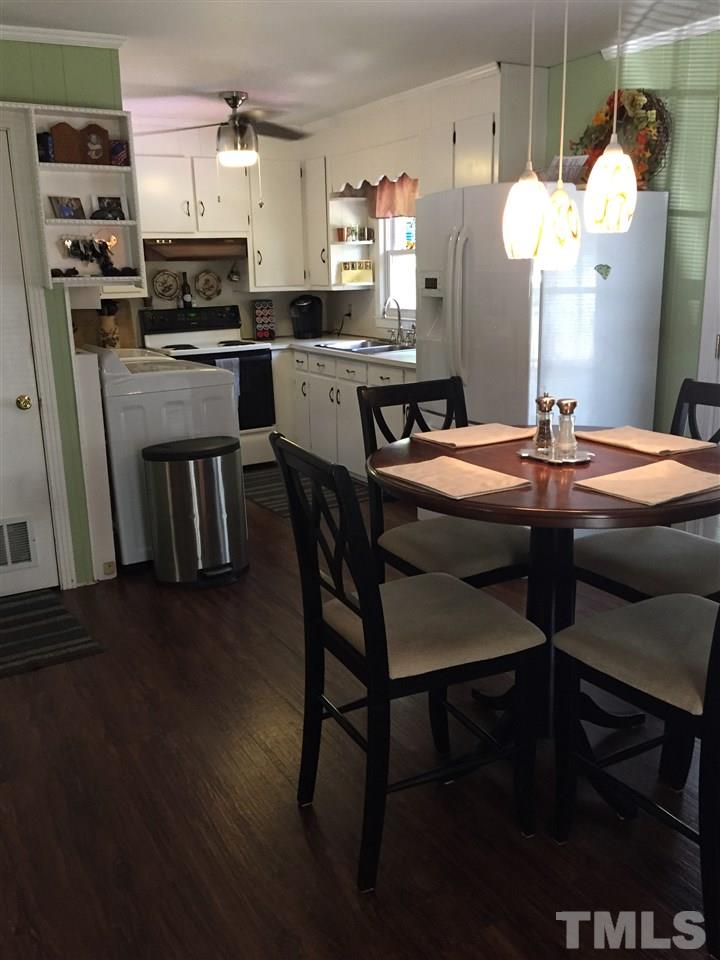 1244 Ridge Road Roxboro, NC 27573 - Photo 5 of 22 a kitchen with kitchen island a stove a table and chairs in it