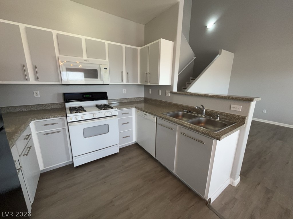 4915 East Russell Road, Unit 115 Las Vegas, NV 89120 - Photo 2 of 7 This functional kitchen features ample counter space and appliances, with an adjacent staircase for seamless flow.