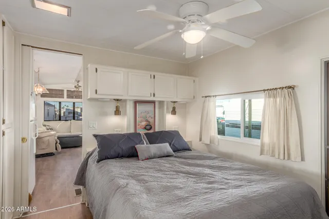 a bedroom with a bed and a large window