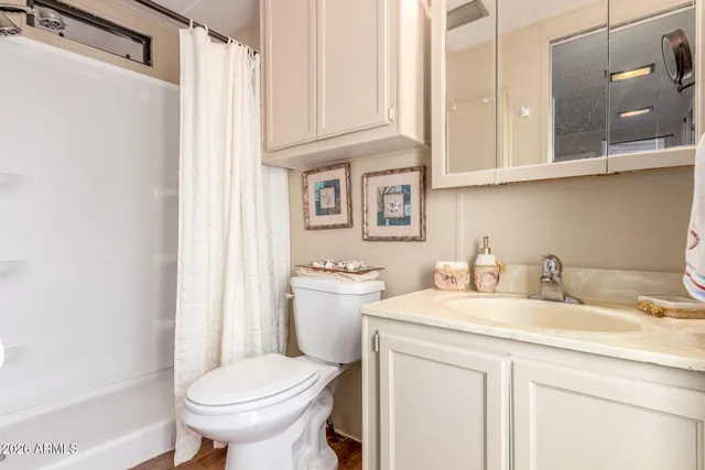 a spacious bedroom with a bed and a chandelier