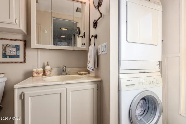 a bathroom with a granite countertop toilet sink and mirror