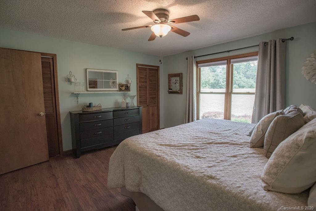 3316 Griffith Road Monroe, NC 28112 - Photo 12 of 28 a bedroom with a bed and a chandelier