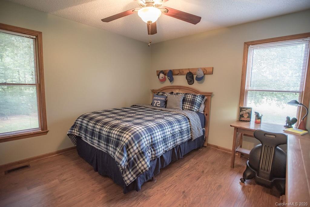 3316 Griffith Road Monroe, NC 28112 - Photo 13 of 28 a bedroom with a bed a chandelier and a window