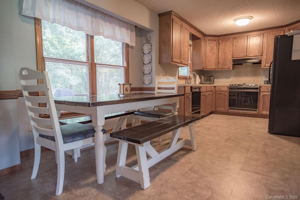 3316 Griffith Road Monroe, NC 28112 - Photo 20 of 28 a kitchen with a stove a sink and a refrigerator