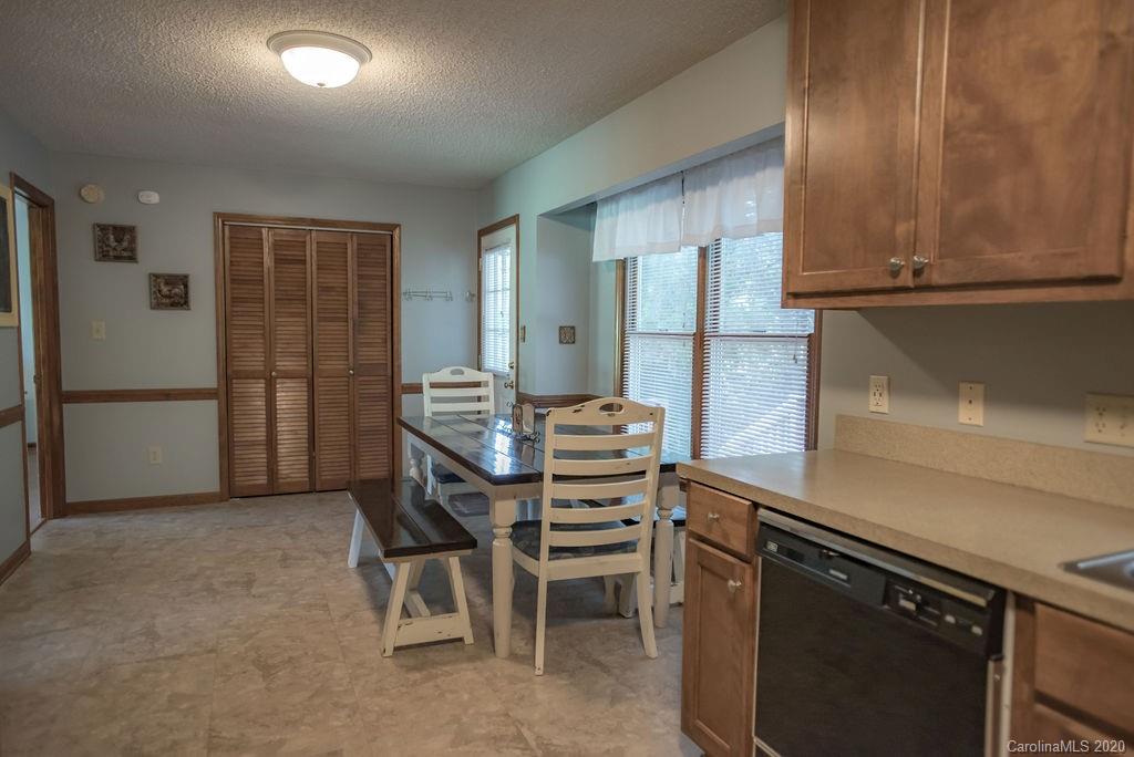 3316 Griffith Road Monroe, NC 28112 - Photo 21 of 28 a kitchen with a refrigerator and cabinets