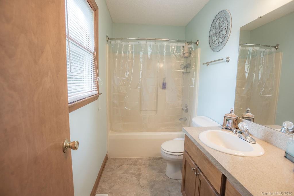 3316 Griffith Road Monroe, NC 28112 - Photo 23 of 28 a bathroom with a sink toilet a shower and a mirror