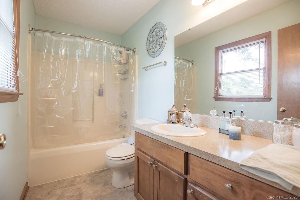 3316 Griffith Road Monroe, NC 28112 - Photo 24 of 28 a bathroom with a granite countertop sink a toilet and shower