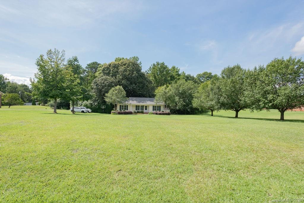 3316 Griffith Road Monroe, NC 28112 - Photo 4 of 28 a swimming pool with trees in the background