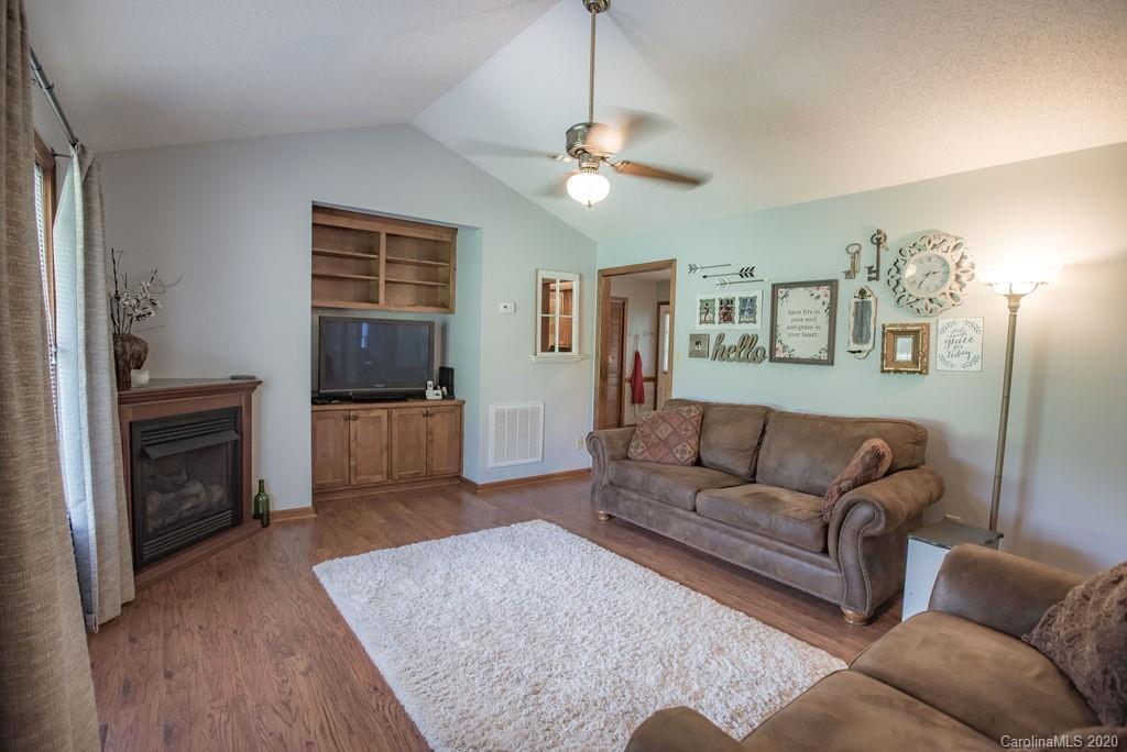 3316 Griffith Road Monroe, NC 28112 - Photo 8 of 28 a living room with furniture and a fireplace
