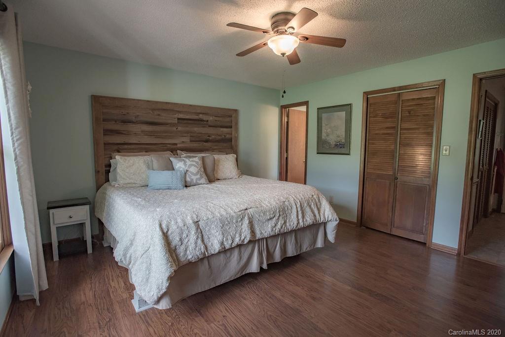 3316 Griffith Road Monroe, NC 28112 - Photo 10 of 28 a bedroom with a large bed and a chandelier