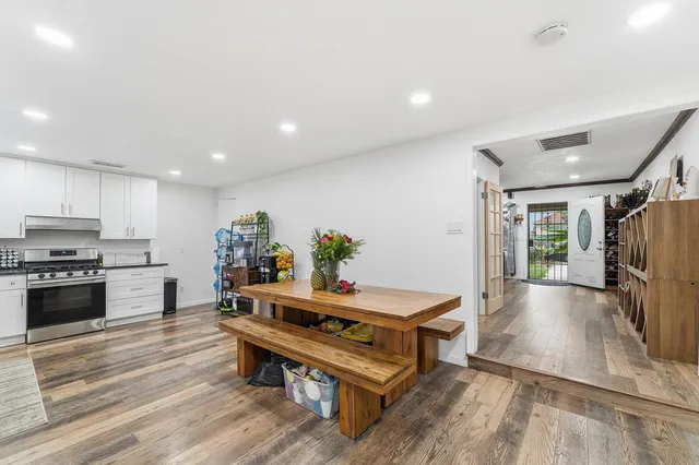 a living room with furniture and a kitchen view