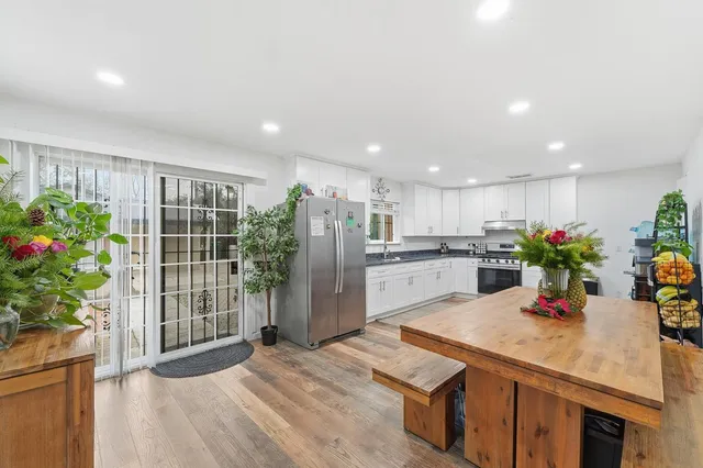 a kitchen with counter top space and wooden floor