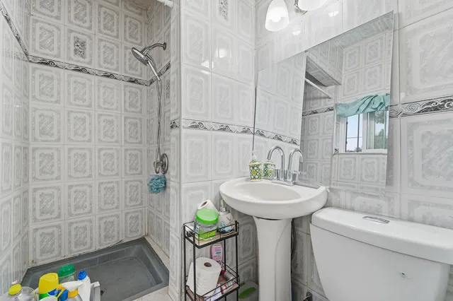 a bathroom with a sink a mirror and a shower