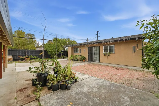 a view of a house with potted plants