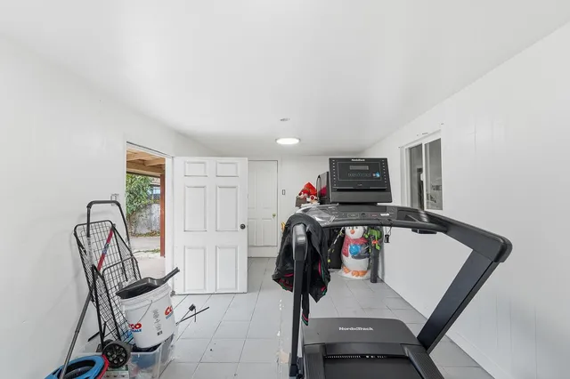 a view of a livingroom with furniture and gym equipment