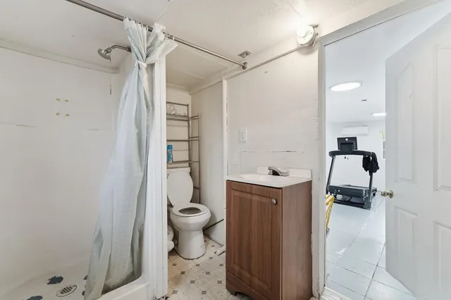 a bathroom with a sink toilet and shower