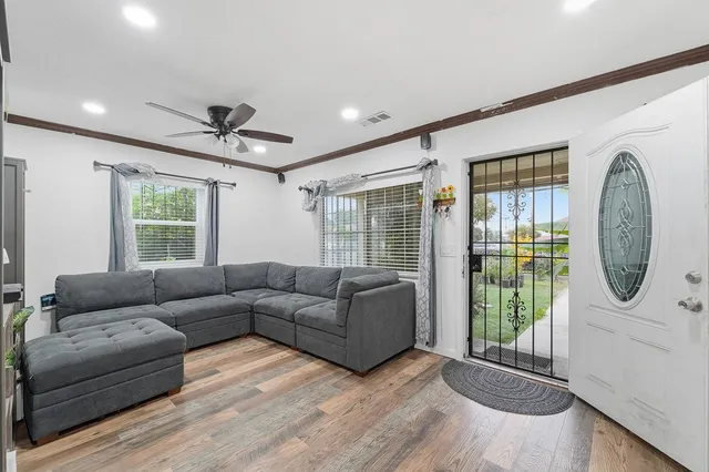 a living room with furniture a window and a chandelier