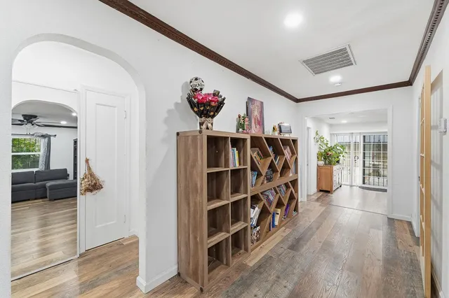 a view of a hallway with wooden floor and entryway
