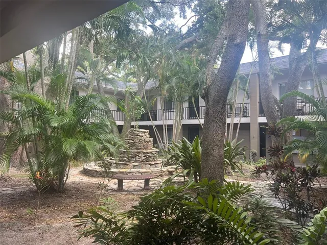 a front view of a house with cars parked