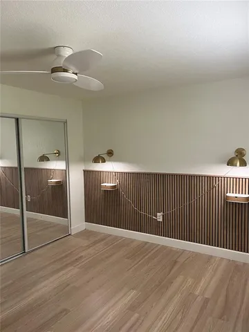a bathroom with a granite countertop toilet sink and mirror