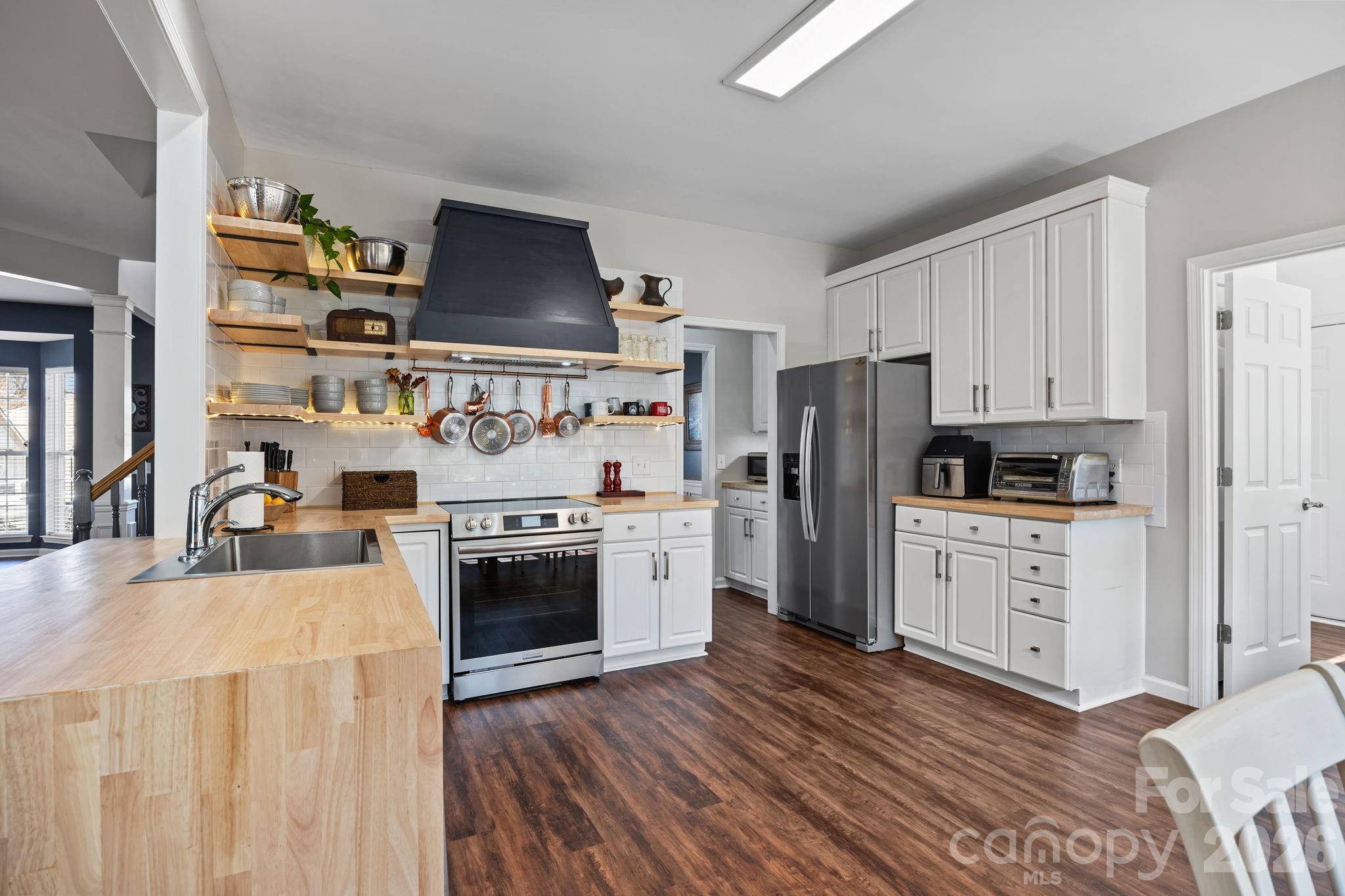 173 Coronilla Road Mooresville, NC 28117 - Photo 13 of 41 a kitchen with stainless steel appliances a stove a refrigerator and white cabinets