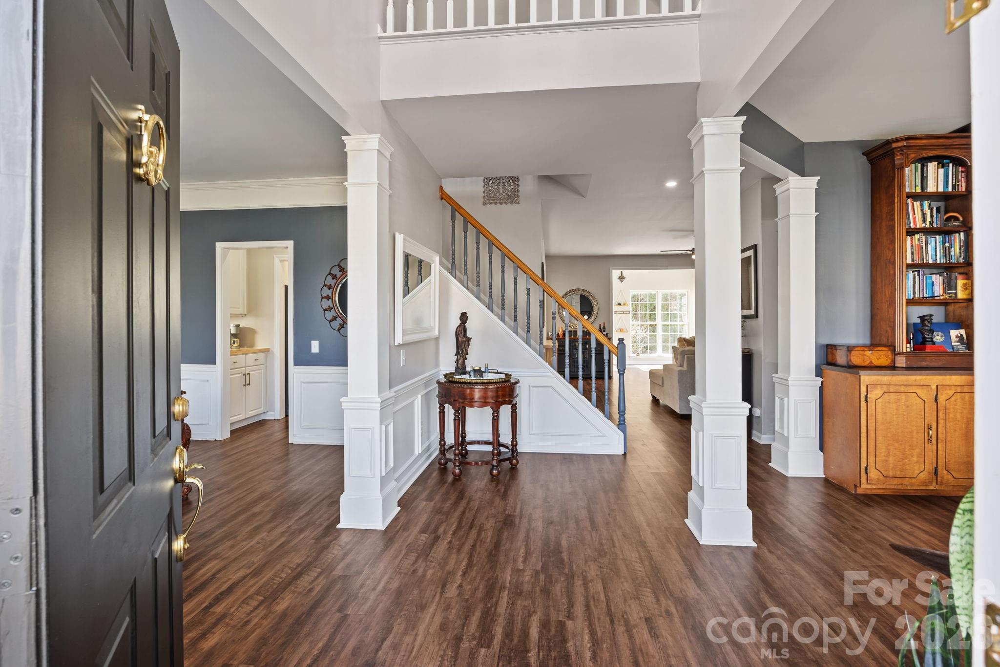 173 Coronilla Road Mooresville, NC 28117 - Photo 2 of 41 a view of a hallway with wooden floor and stairs