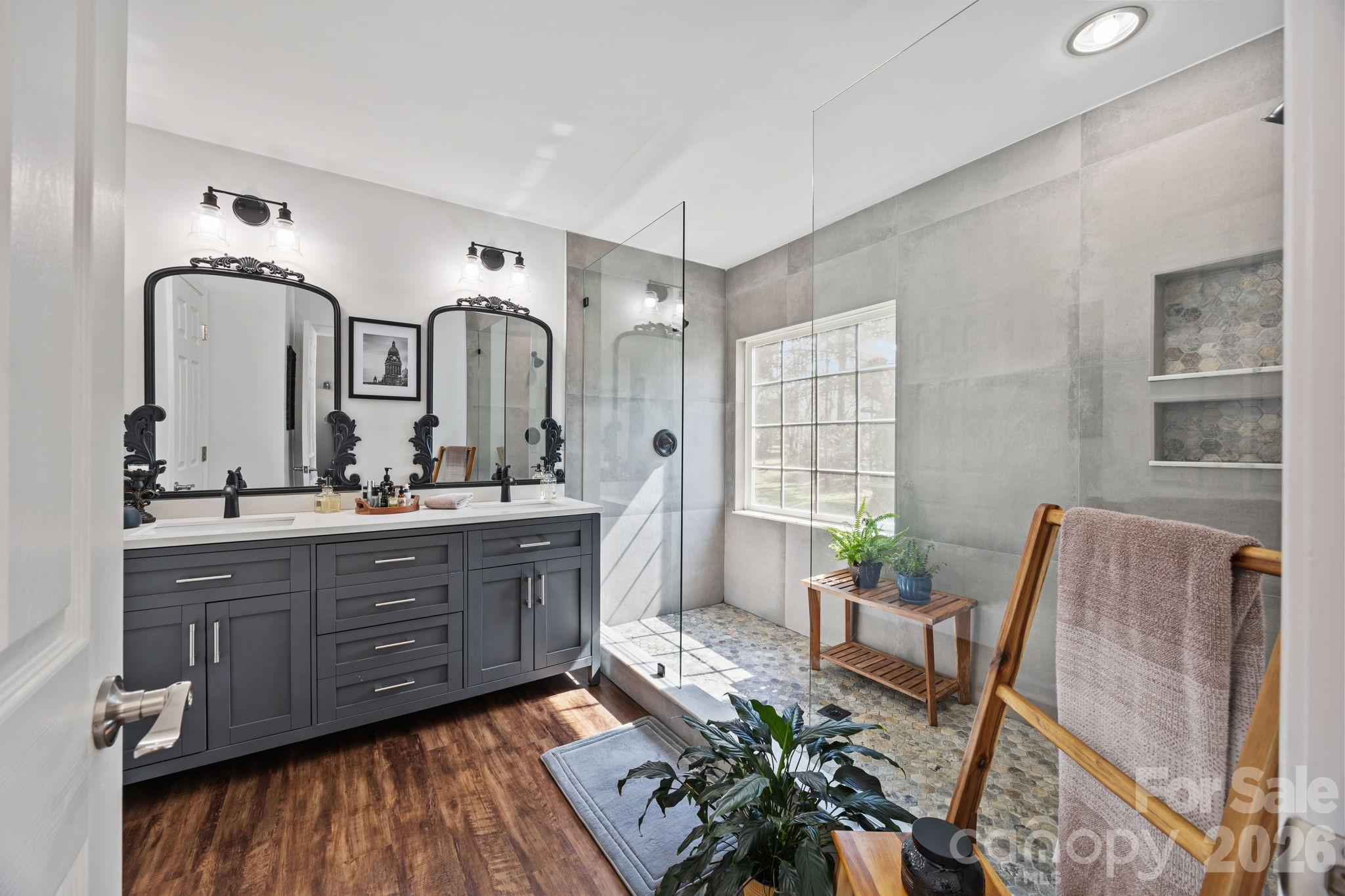 173 Coronilla Road Mooresville, NC 28117 - Photo 23 of 41 a spacious bathroom with a granite countertop tub a double vanity sink and a large mirror