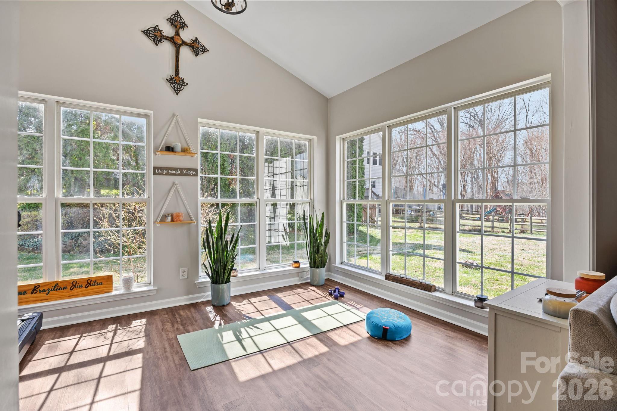 173 Coronilla Road Mooresville, NC 28117 - Photo 8 of 41 a living room with furniture and floor to ceiling windows