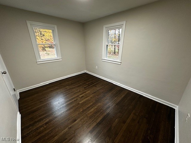 10488 Dewhurst Road Elyria, OH 44035 - Photo 15 of 22 Empty room featuring dark wood-style flooring and baseboards