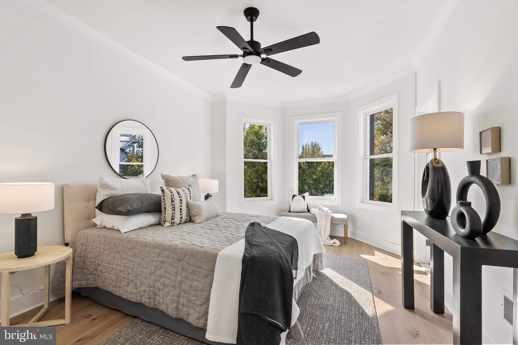 1361 Spring Road Northwest Washington, DC 20010 - Photo 16 of 40 a bedroom with a bed window and a chandelier