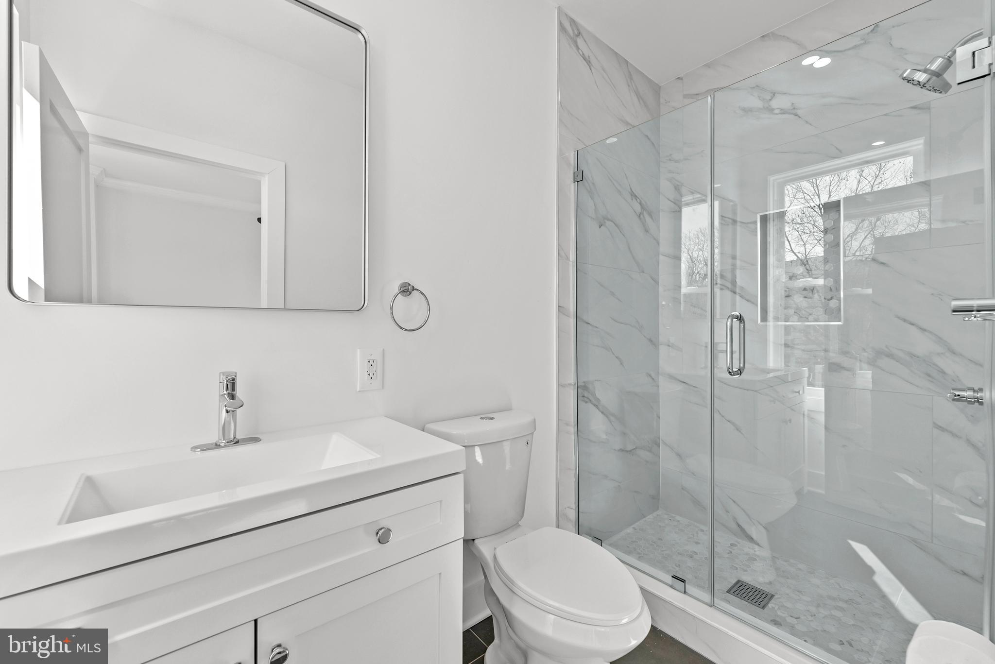 1361 Spring Road Northwest Washington, DC 20010 - Photo 19 of 40 a bathroom with a sink a toilet and shower