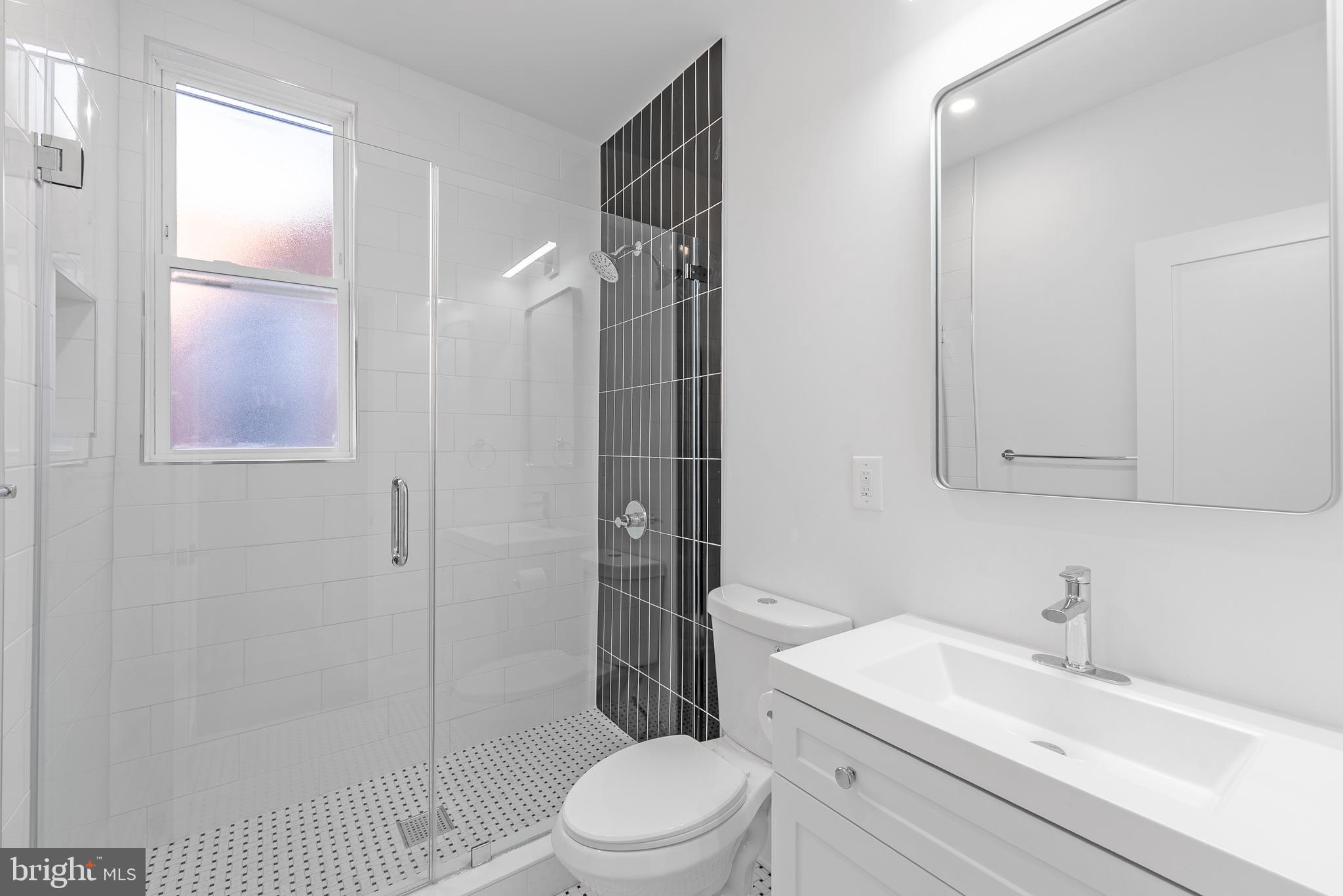 1361 Spring Road Northwest Washington, DC 20010 - Photo 24 of 40 a bathroom with a sink toilet vanity and shower