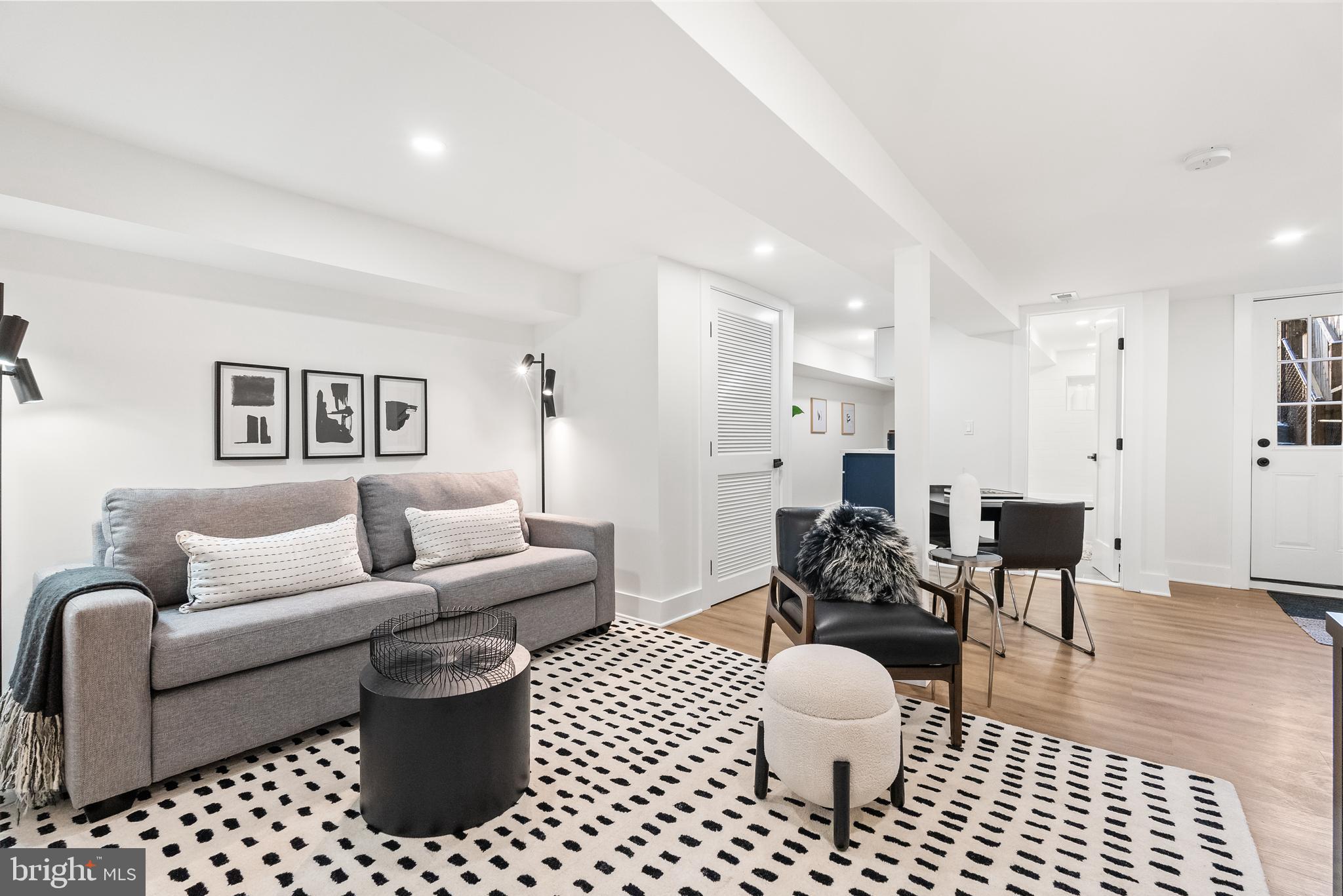 1361 Spring Road Northwest Washington, DC 20010 - Photo 28 of 40 a living room with furniture a rug and a chandelier