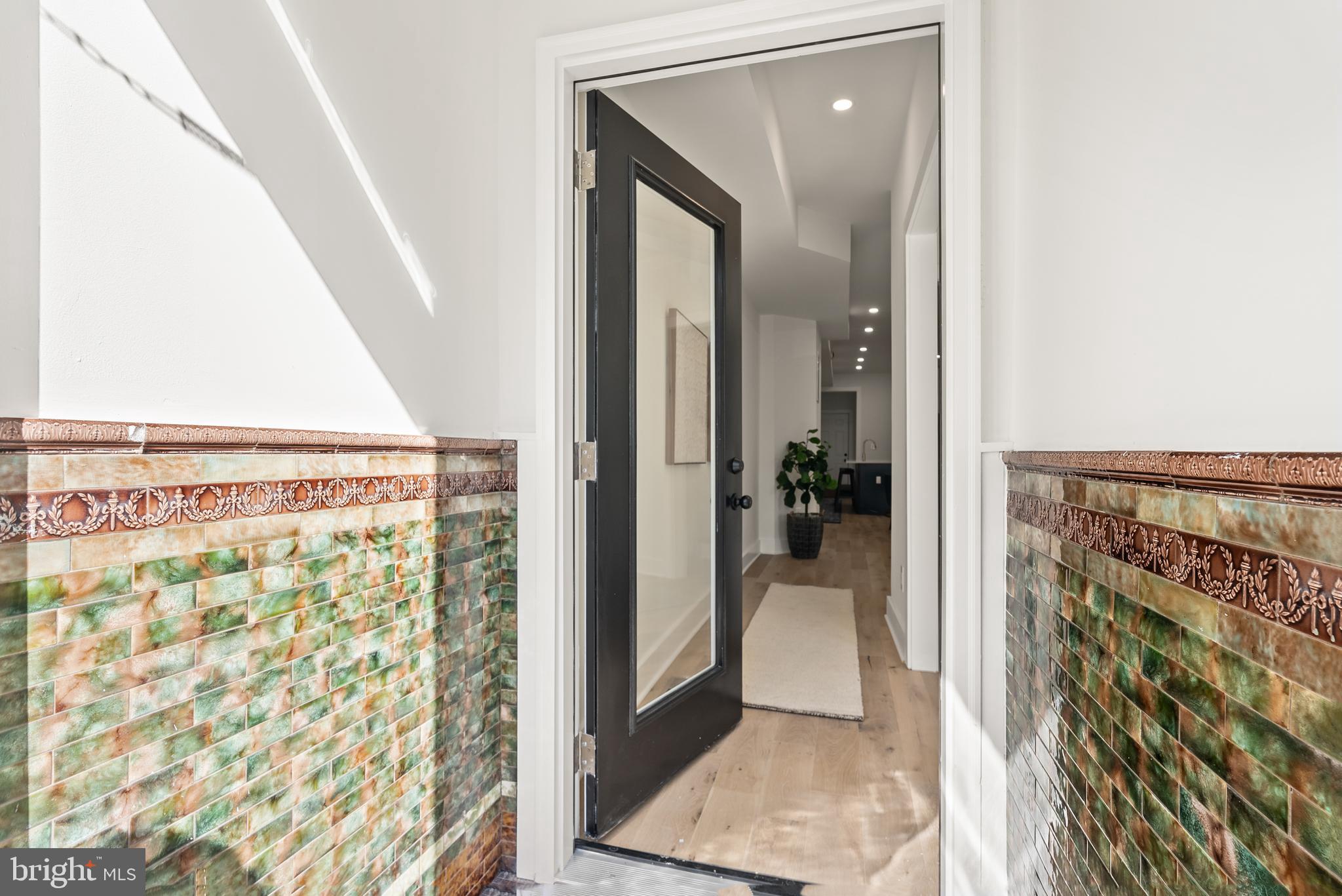 1361 Spring Road Northwest Washington, DC 20010 - Photo 2 of 40 a view of a hallway with wooden floor and a living room