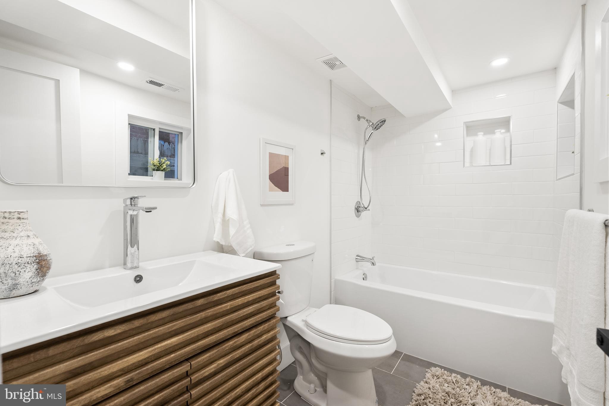 1361 Spring Road Northwest Washington, DC 20010 - Photo 30 of 40 a bathroom with a sink a toilet and shower