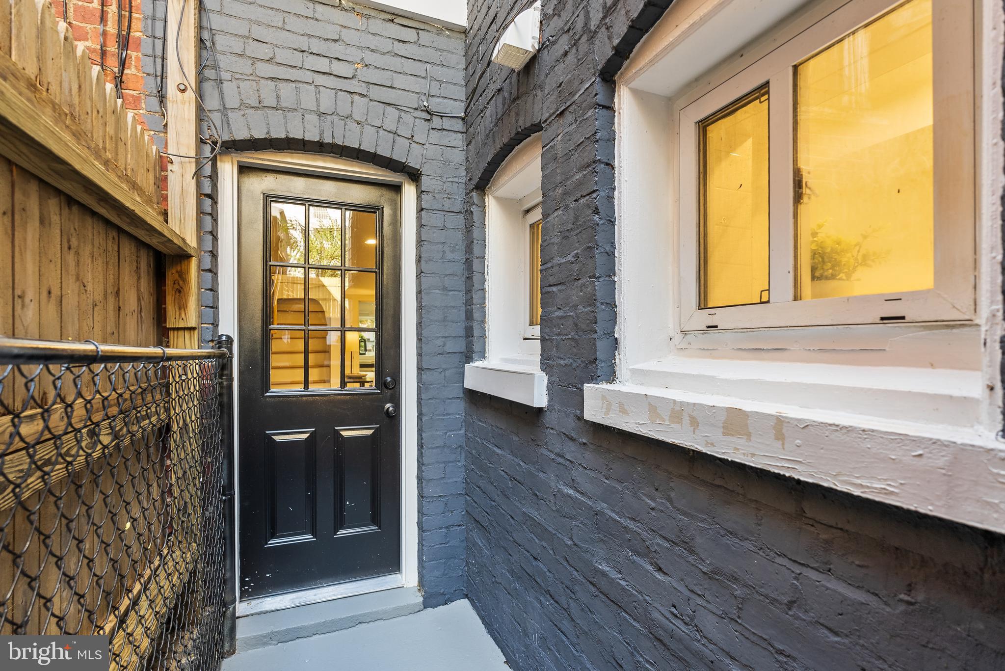 1361 Spring Road Northwest Washington, DC 20010 - Photo 37 of 40 a view of a brick house with a large window