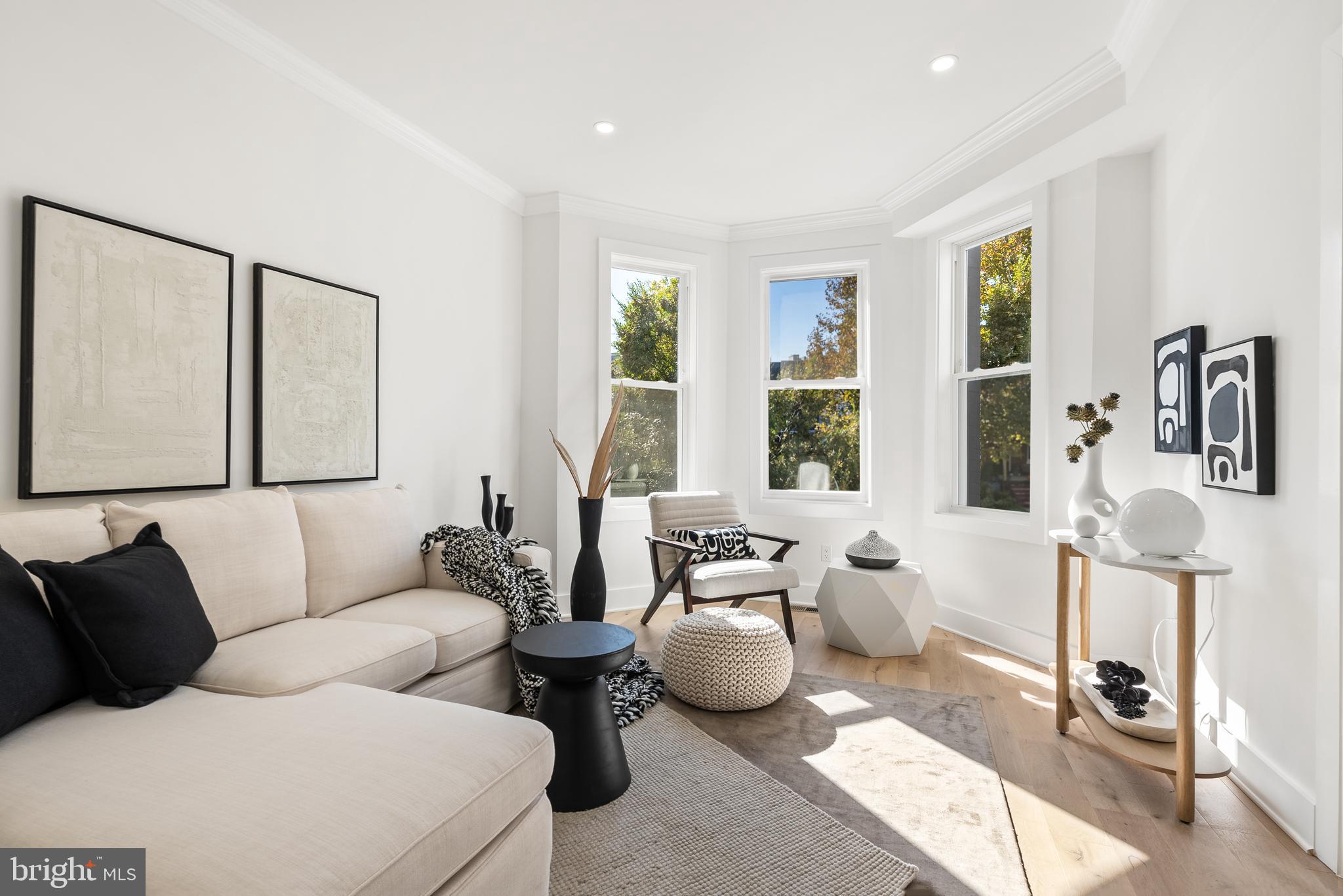 1361 Spring Road Northwest Washington, DC 20010 - Photo 5 of 40 a living room with furniture and large windows