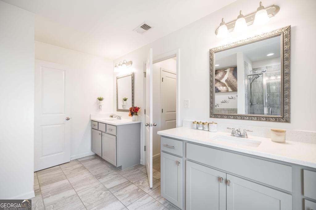 209 Adirondac Way Bonaire, GA 31005 - Photo 11 of 22 a bathroom with a sink vanity and mirror